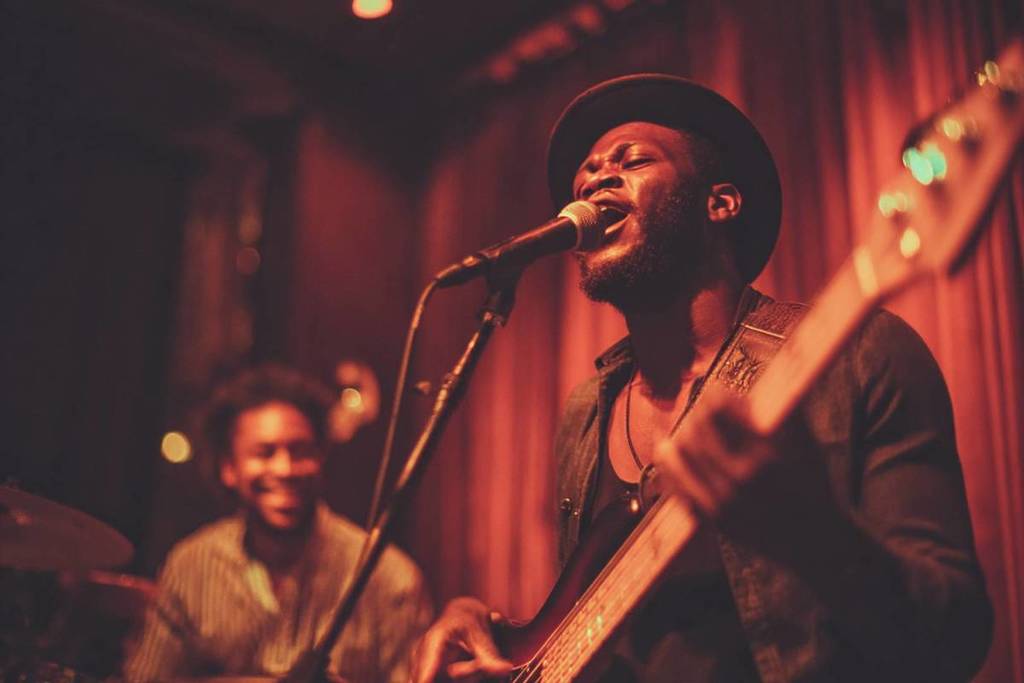 A soul artist singing and playing the guitar