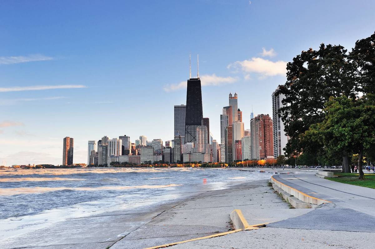 Chicago city urban skyscraper at downtown lakefront at sunset with Lake Michigan viewed from North Avenue Beach.