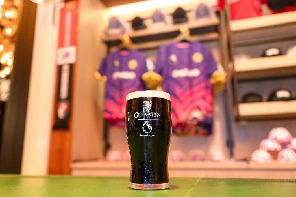 A pint of Guinness sits in front of Premier League merchandise during the Premier League House Takeover at Guinness Open Gate Brewery on July 28, 2025 in Chicago, Illinois. (Photo by Daniel Bartel/Getty Images)