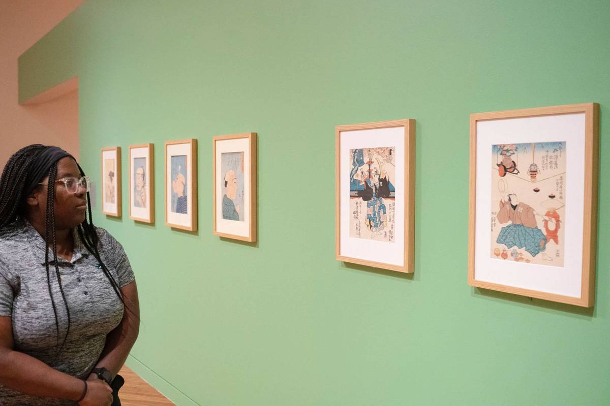 woman viewing Japanese prints in museum