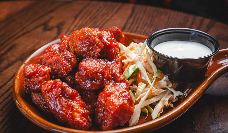 Wing champion Woodie’s Flat launches Malört BBQ sauce wings for a limited time