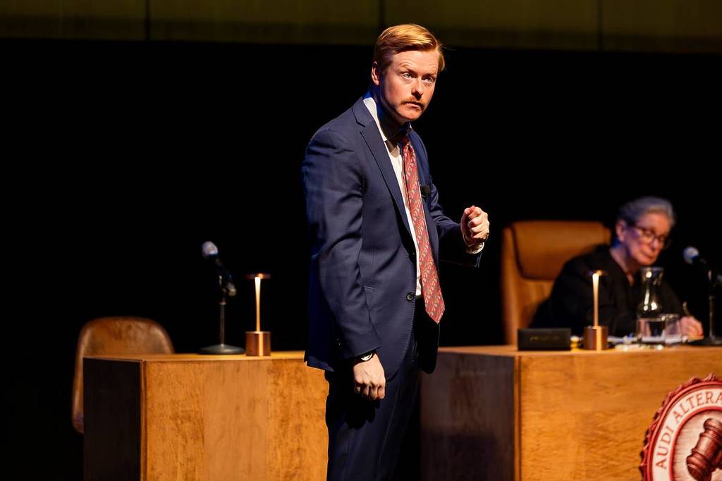 A lawyer stands before the court at The Jury Experience.