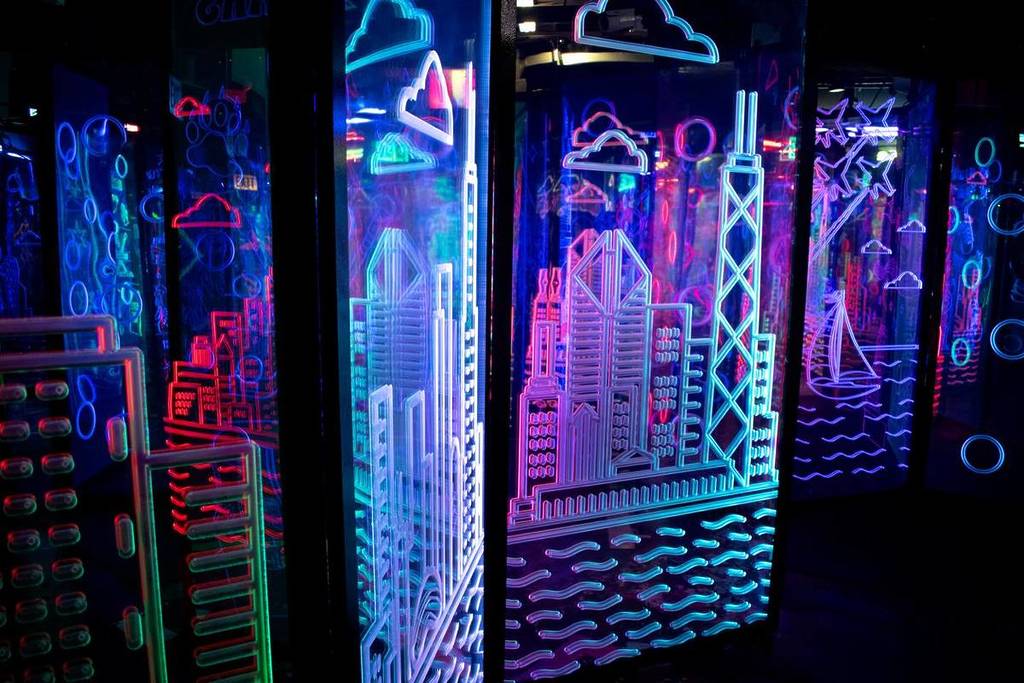 Neon etchings of the Chicago skyline at Amazing Chicago's Funhouse Maze.