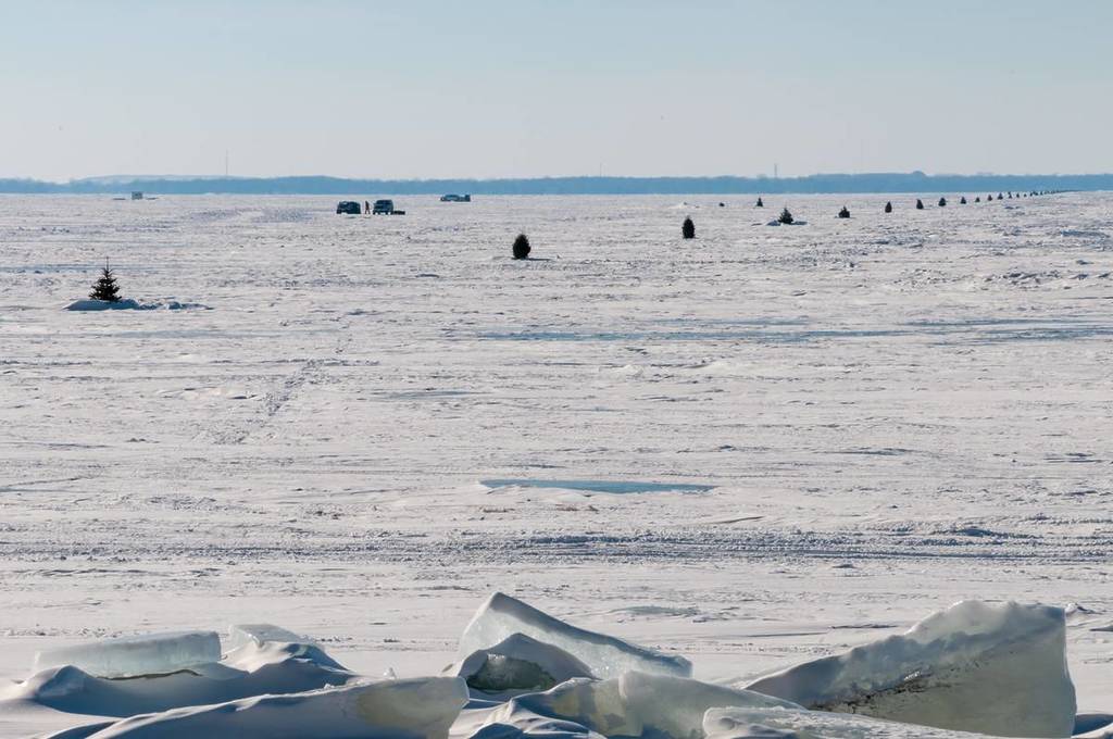 Christmas trees marking a safe path for vehicles across a frozen Lake Winnebago, Wisconsin