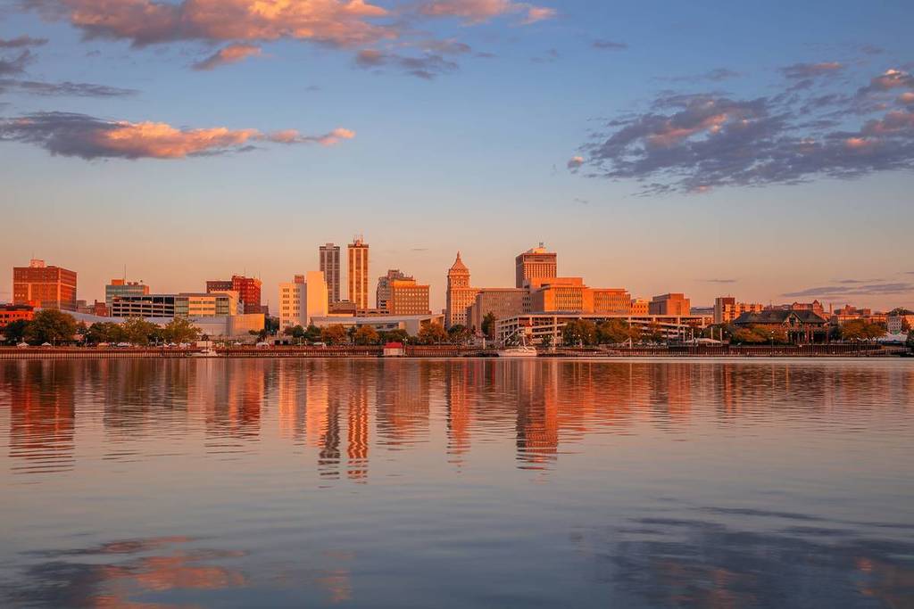 Peoria, Illinois, USA. Cityscape image of Peoria skyline, Illinois, USA with reflection of city lights in the Illinois River at autumn sunrise.