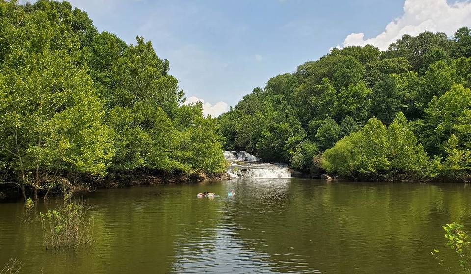 This hidden 3-level waterfall oasis in Illinois features a 15-foot deep swimming hole and a 2,750-acre lake