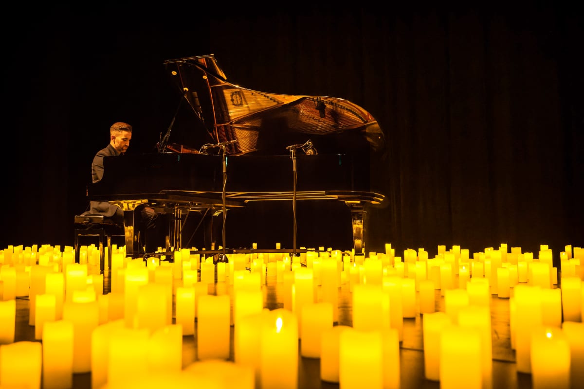 A pianist performing by candlelight
