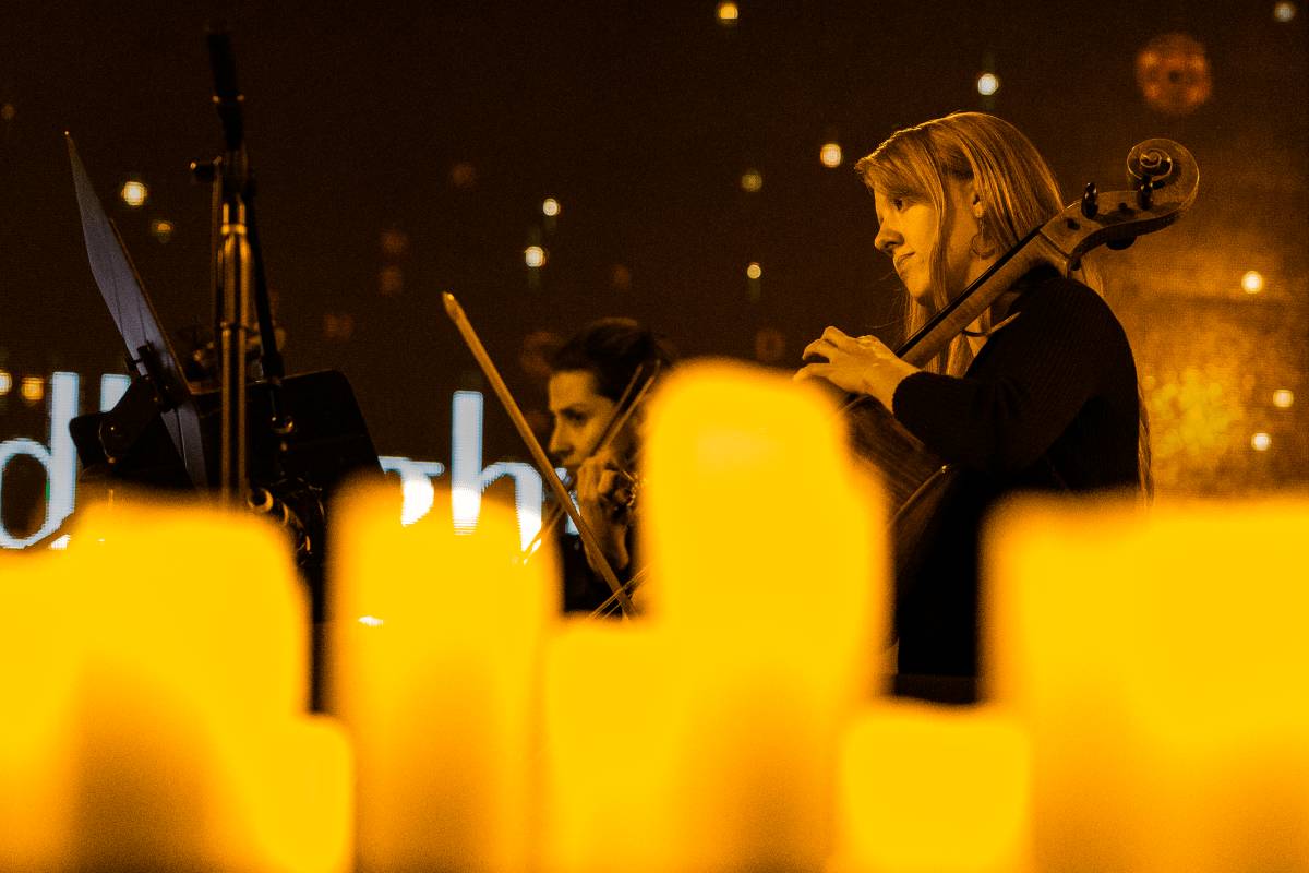Two members of a string quartet performing by candlelight