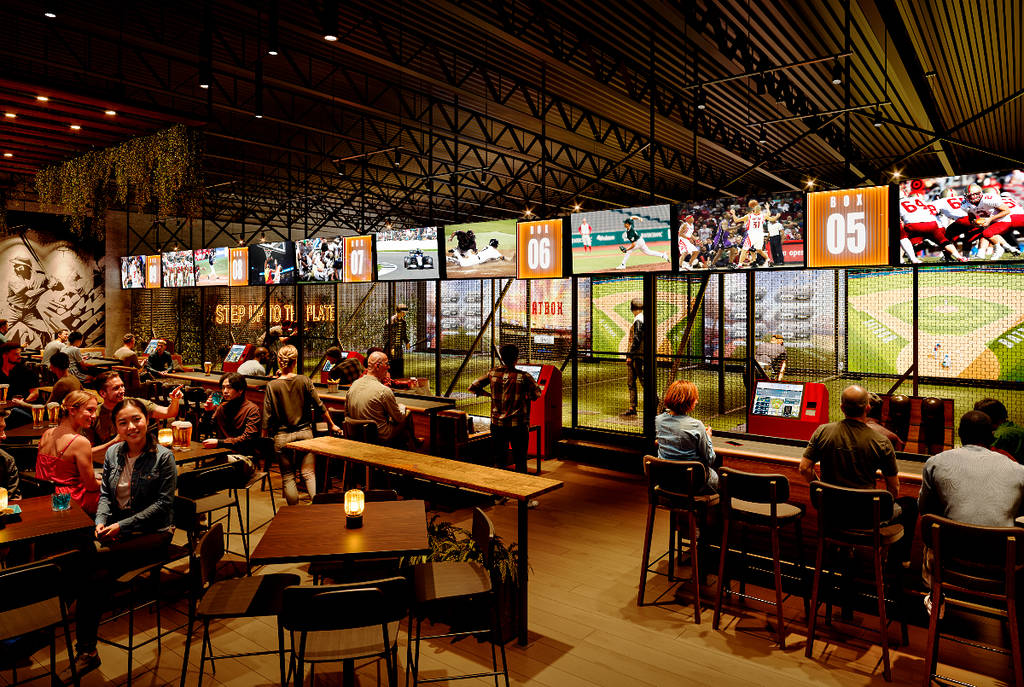 Image shows the bar/dining area and baseball simulators at the Batbox baseball-themed entertainment venue in Dallas.