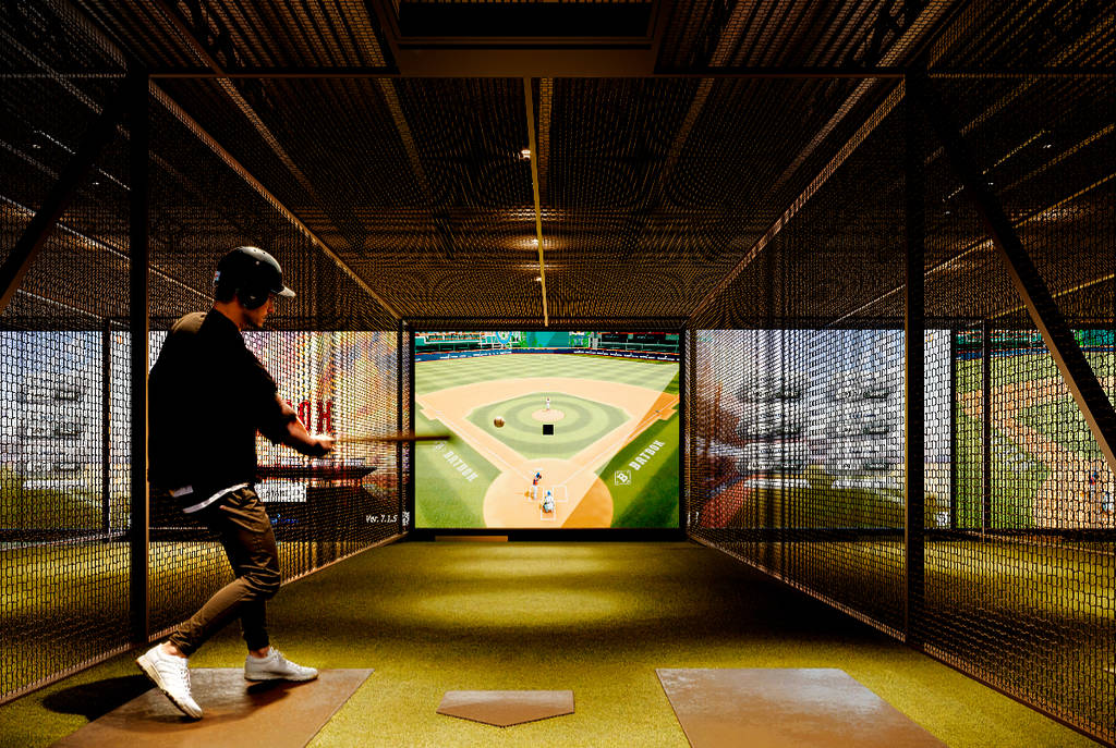 Image shows a guy participating in a baseball simulator at Batbox.