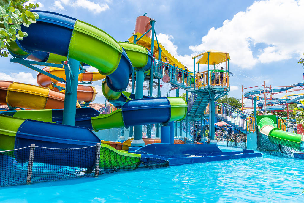 Image shows a slide and a pool at a waterpark.