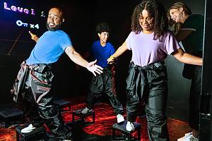 Guests make their way through Glow or Go's challenge rooms