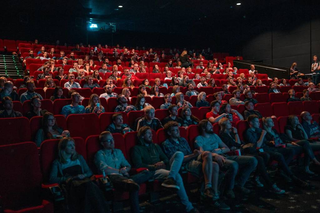 An audience watching a late night screening of a movie at a cinema
