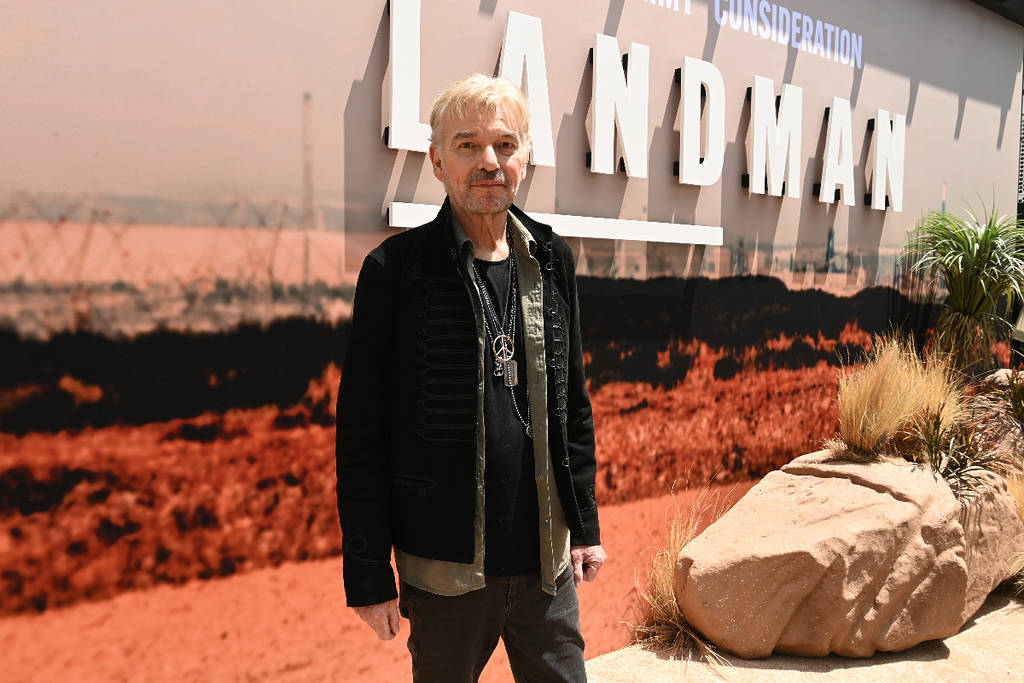 Image shows Billy Bob Thornton posing in front of a 'Landman' sign.
