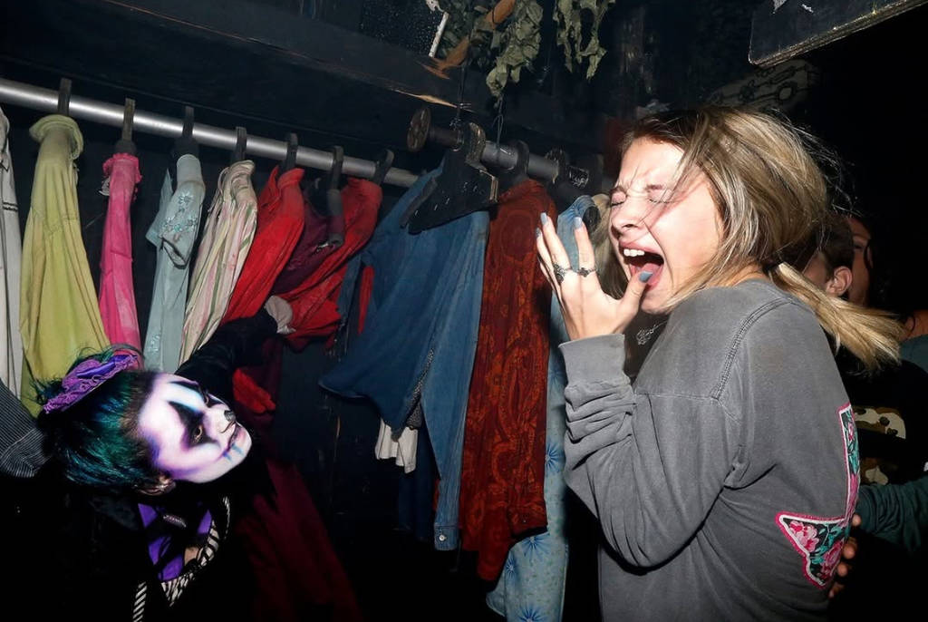 Image shows a visitor being scared by an actor at Cutting Edge Haunted House in Fort Worth.