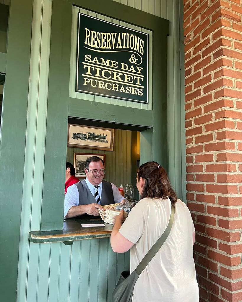 Image shows a woman purchasing tickets at the Grapevine Vintage Railroad.
