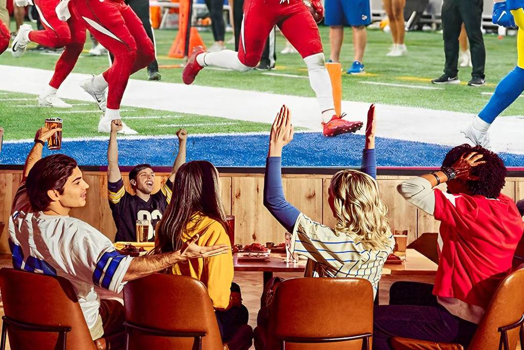 friends watching football at Dave & Buster's