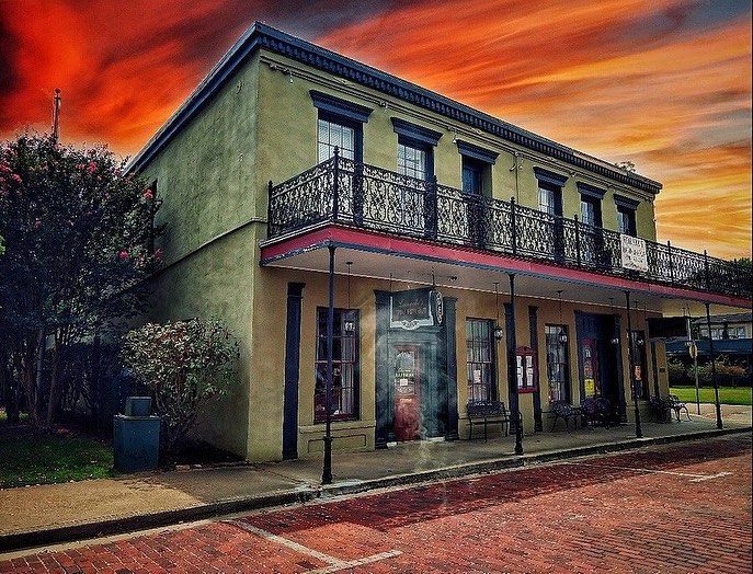 Image shows the facade of the Jefferson Hotel at sunset.