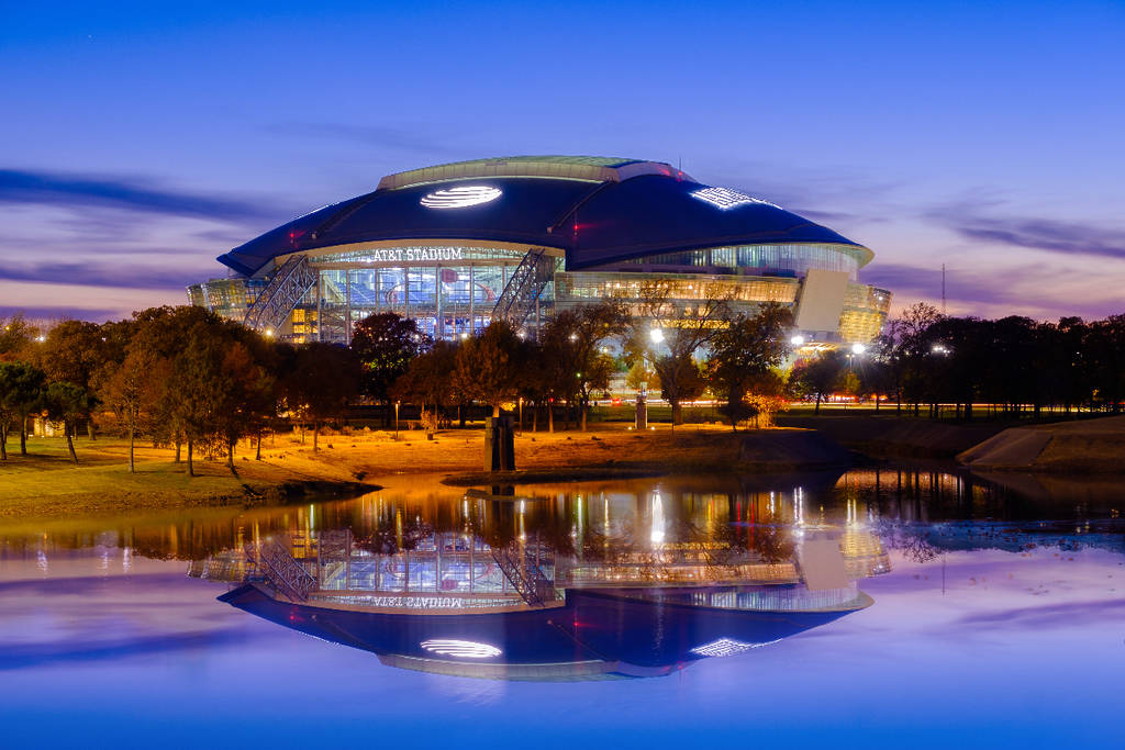 Image shows AT&T Stadium at sunset.