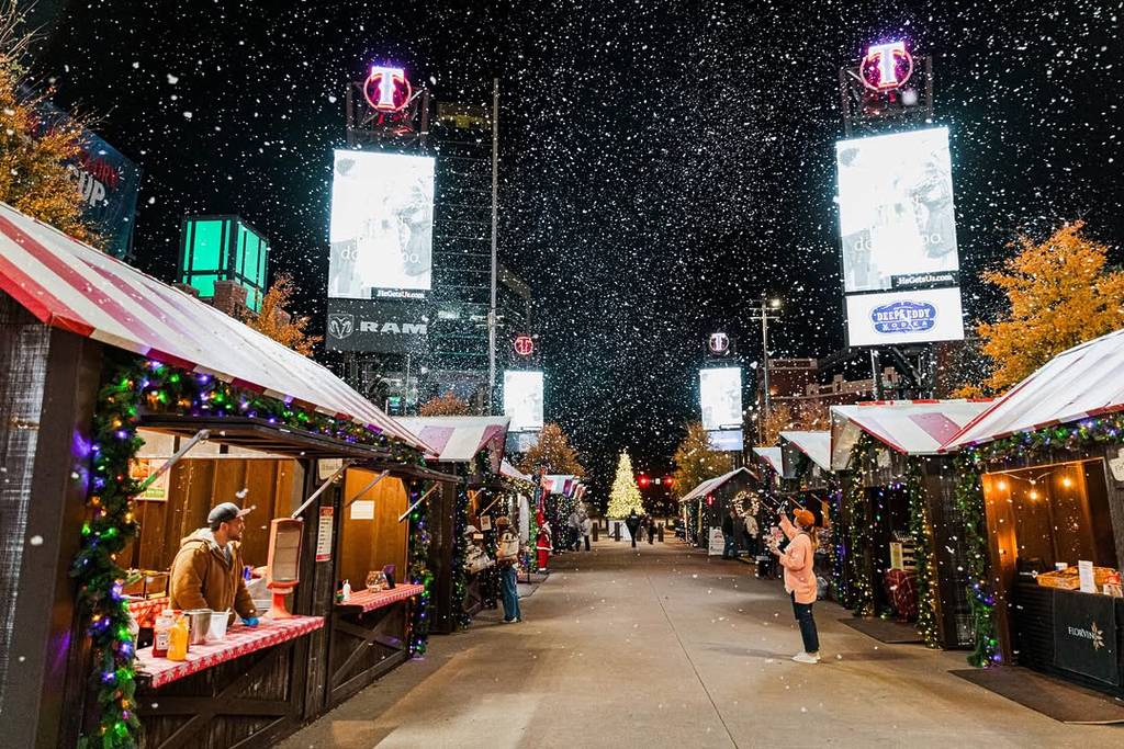 Image shows the Texas Christkindl Market in Arlington during a snowfall.