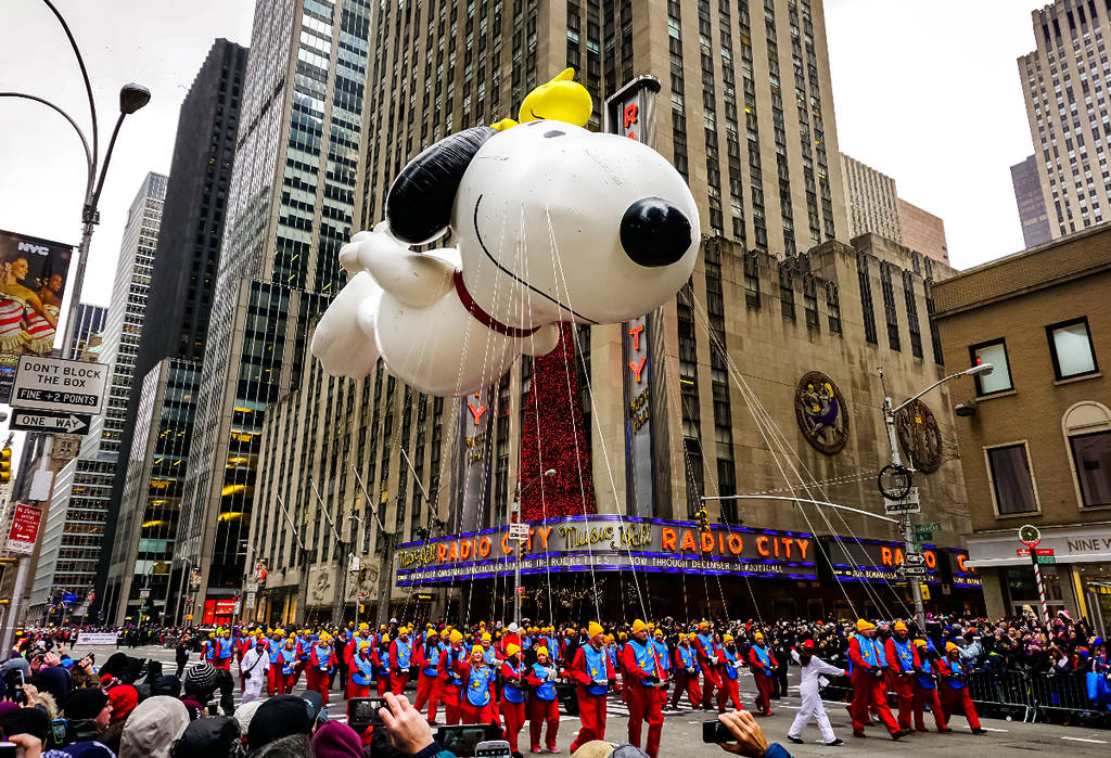 Image shows a large Snoopy float in the Macy's Thanksgiving Parade in New York.