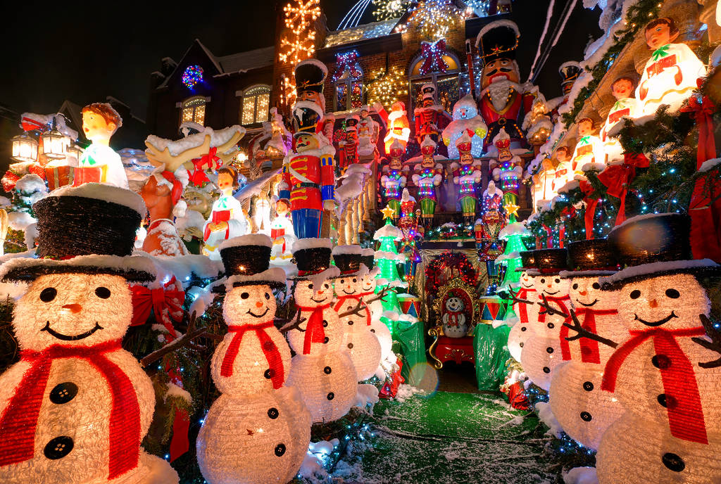 Image shows a heavily decorated for the holidays including a pathway of snowmen, nutcrackers, and lights.
