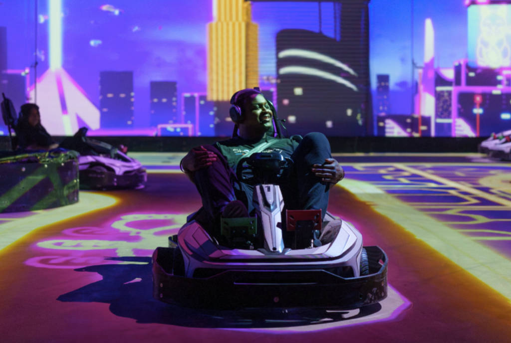 Image shows a man inside a go-kart at Shenaniganz in Rockwall, Texas.