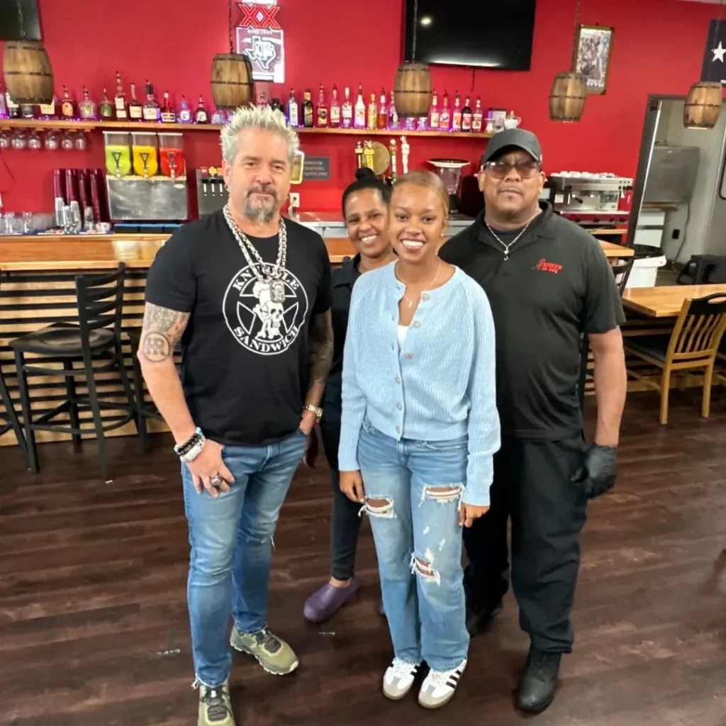 Image shows Smoke N'Ash owner posing for a photo with Guy Fieri.