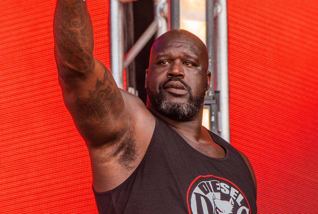 Image shows Shaquille O' Neal posing on stage at his music festival.