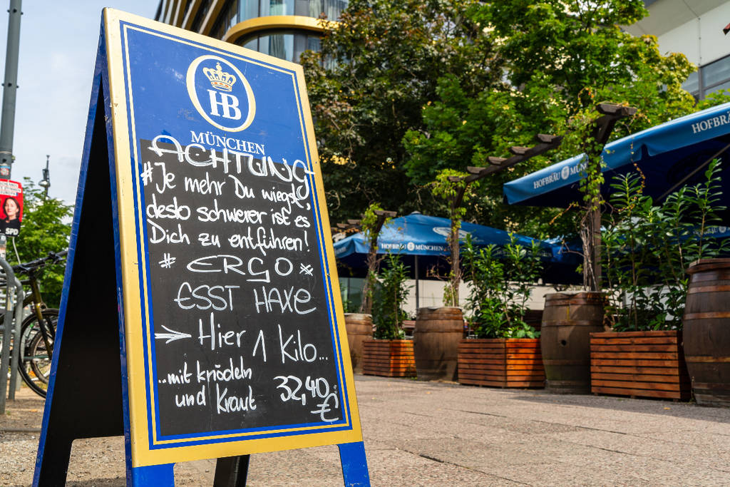 Image shows a sign propped up outside a German beer garden.