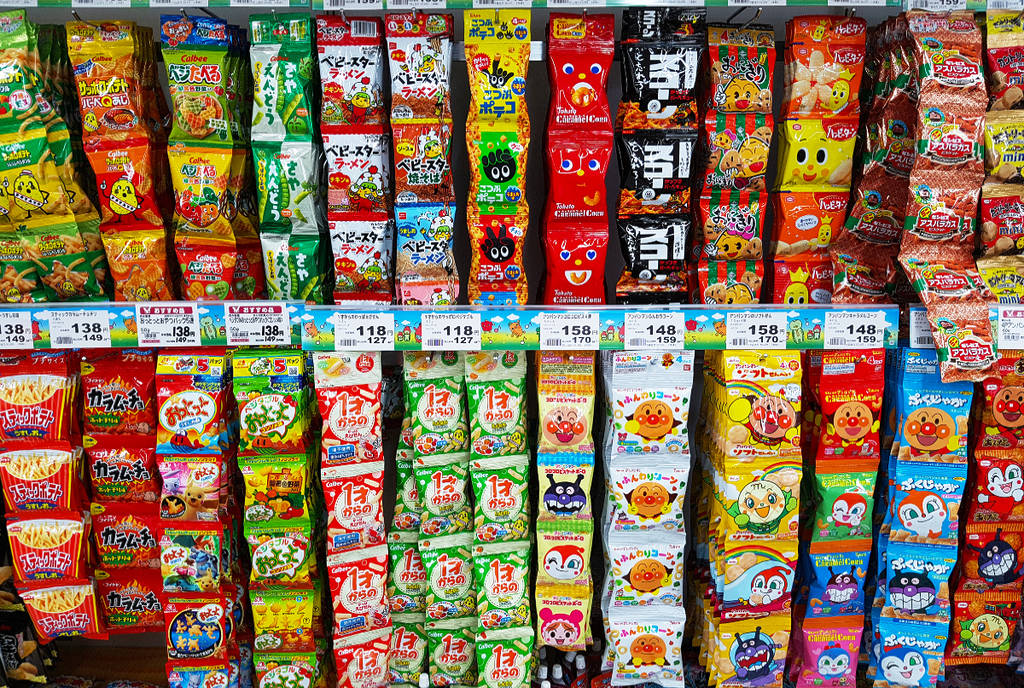Image shows a shelf full of Asian snacks.