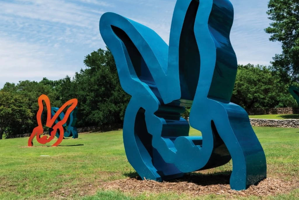 Image shows two rabbit shaped sculptures at Dallas Arboretum.