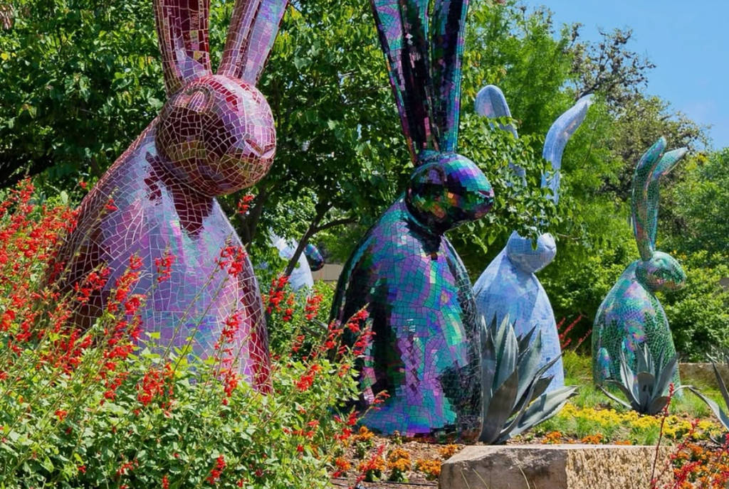 Image shows a row of bunny installations at Dallas Arboretum.