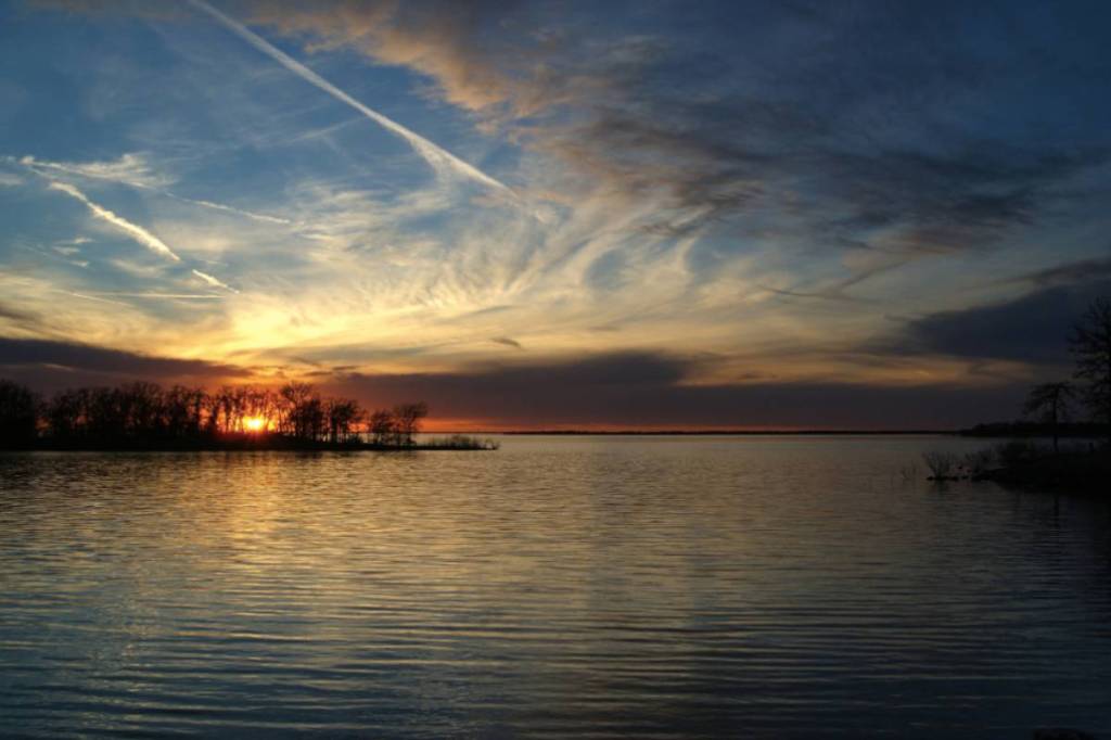 Image shows a sunset over Ray Roberts Lake State Park in Texas. 