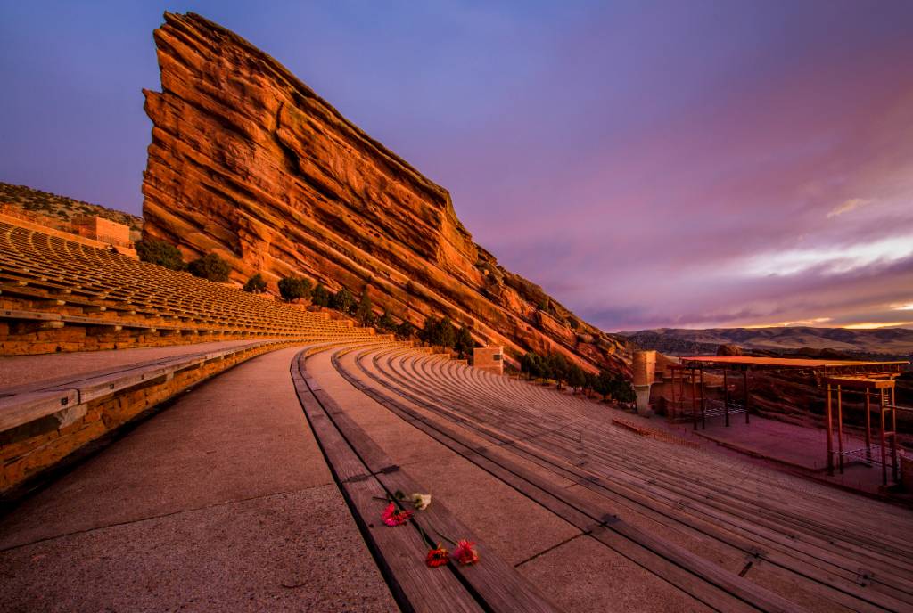 Image shows Red Rocks Amphitheatre at sunset. 