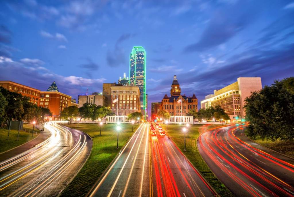 Image shows a Dallas road way lit up at night.