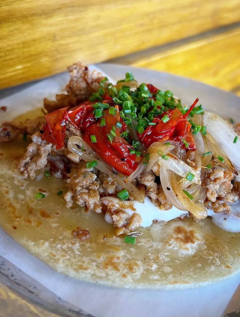 Image shows an italian sausage taco from Resident Taqueria.