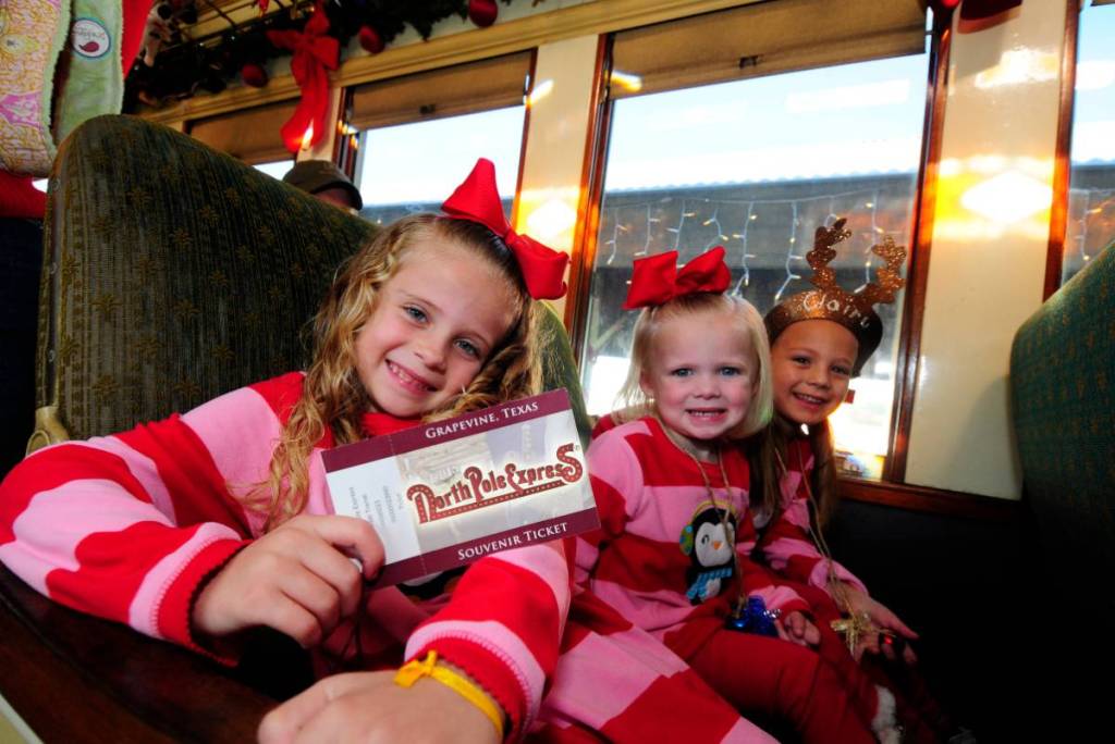 Image shows little kids on a Christmas train. 