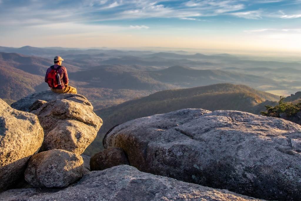 Man enjoying sunrise on Old Rag Mountain in Shenandoah National Park
