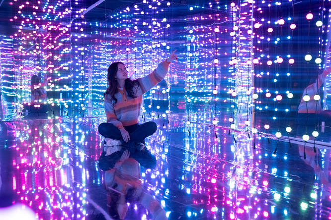woman at Dopamine Land inside a vibrant room