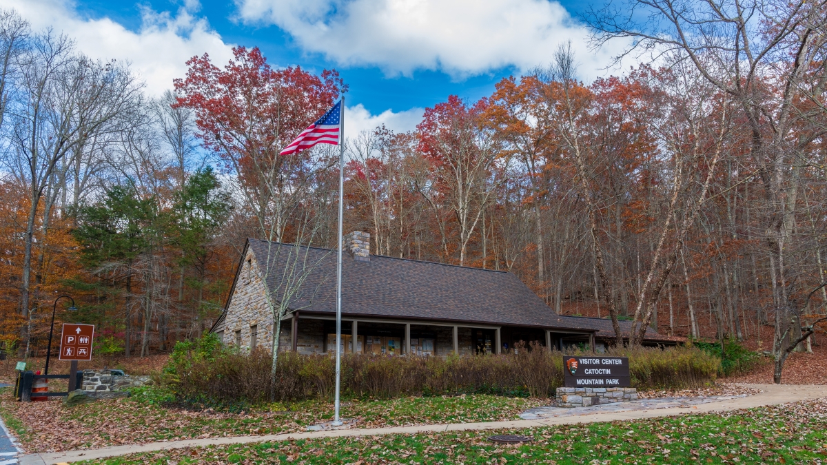 The visitor center for Catoctin Mountain Park on an autumn afternoon with the American flag.