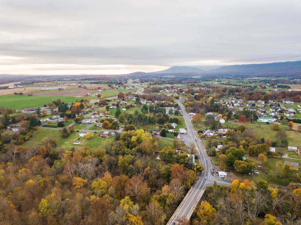 Aerial of a small town in the Shenandoah Valley with Mountains in the Far Distance