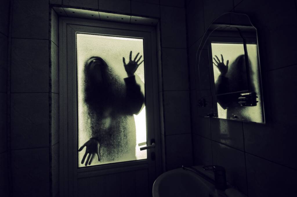 Horror woman in window wood hand hold cage scary scene halloween concept Blurred silhouette of witch