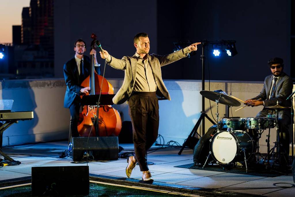 musician and singer preforming atop rooftop