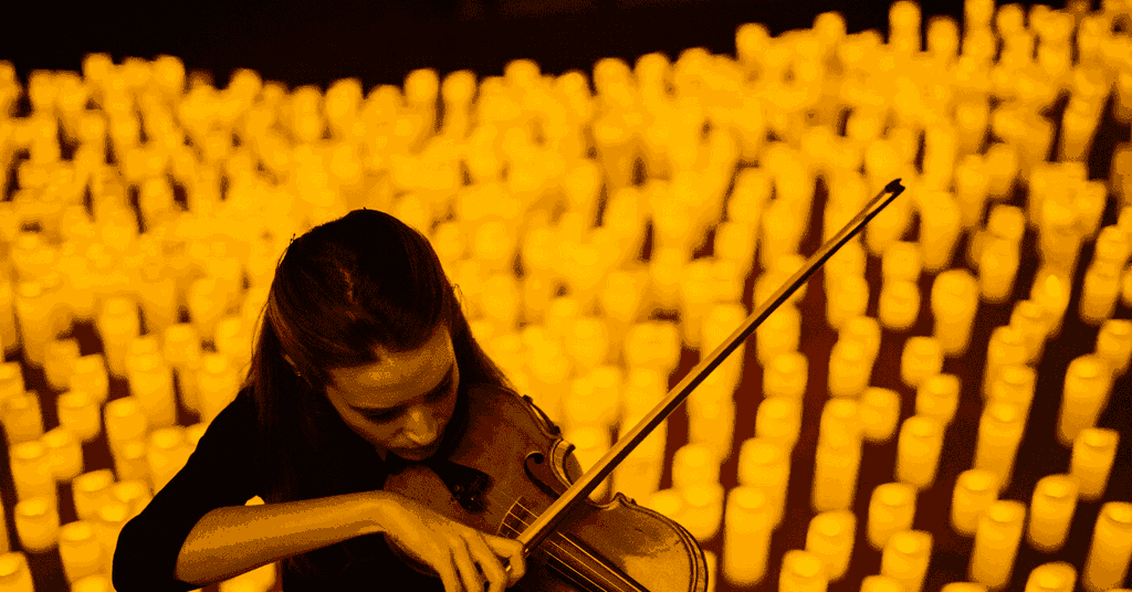 A musician playing the violin at a Candlelight concert