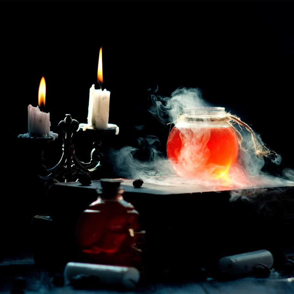 A smoky drink sitting next to two candles
