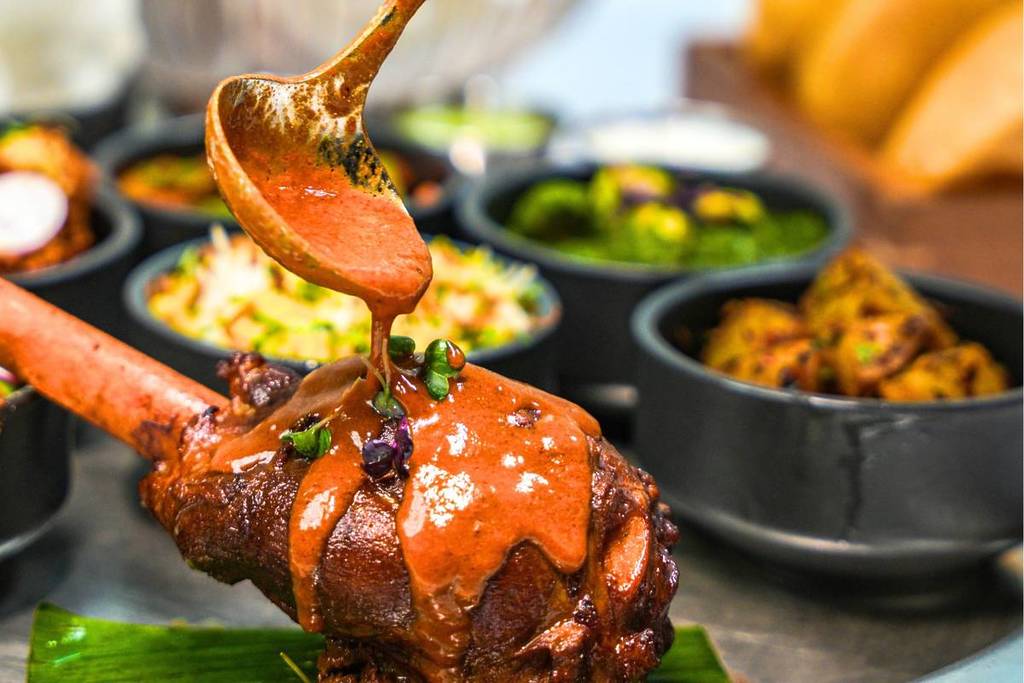 Lamb shank roast drizzled with curry gravy at punjab grill - their indian sunday roast is one of the best things to do this weekend in Dubai