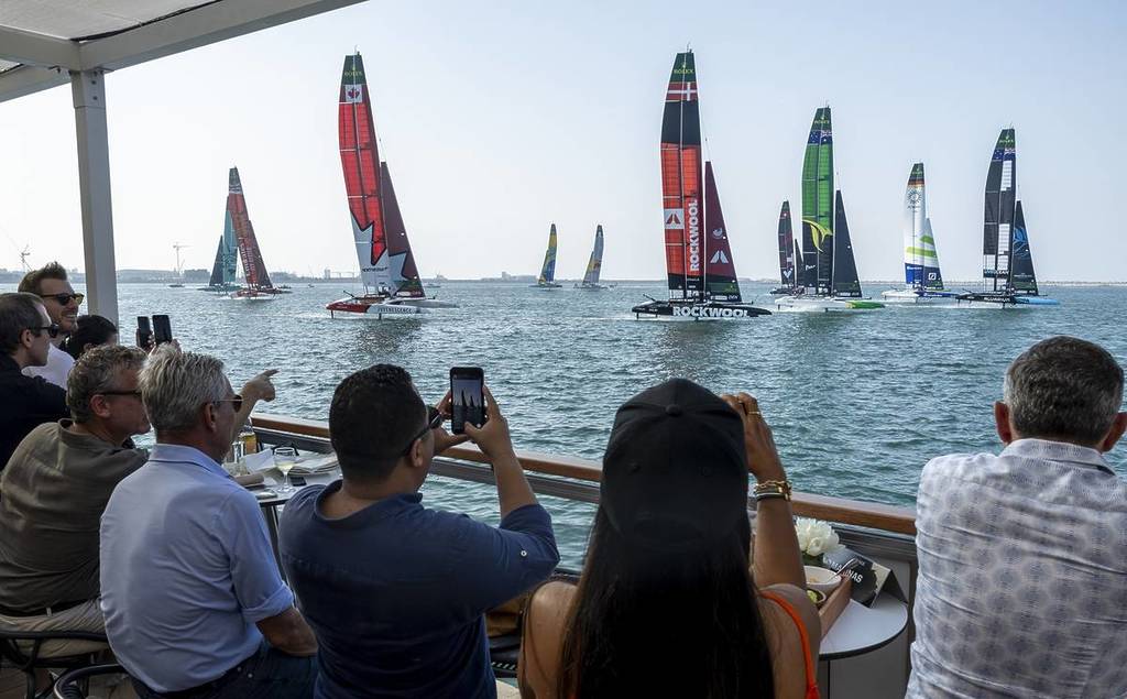 An audience watches the water as foiling catamarans sail past, during a SailGP race in the UAE.