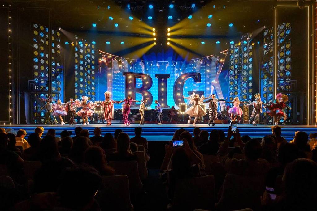 The cast of Once Upon A Time In Dubai centre stage across a large marquee
