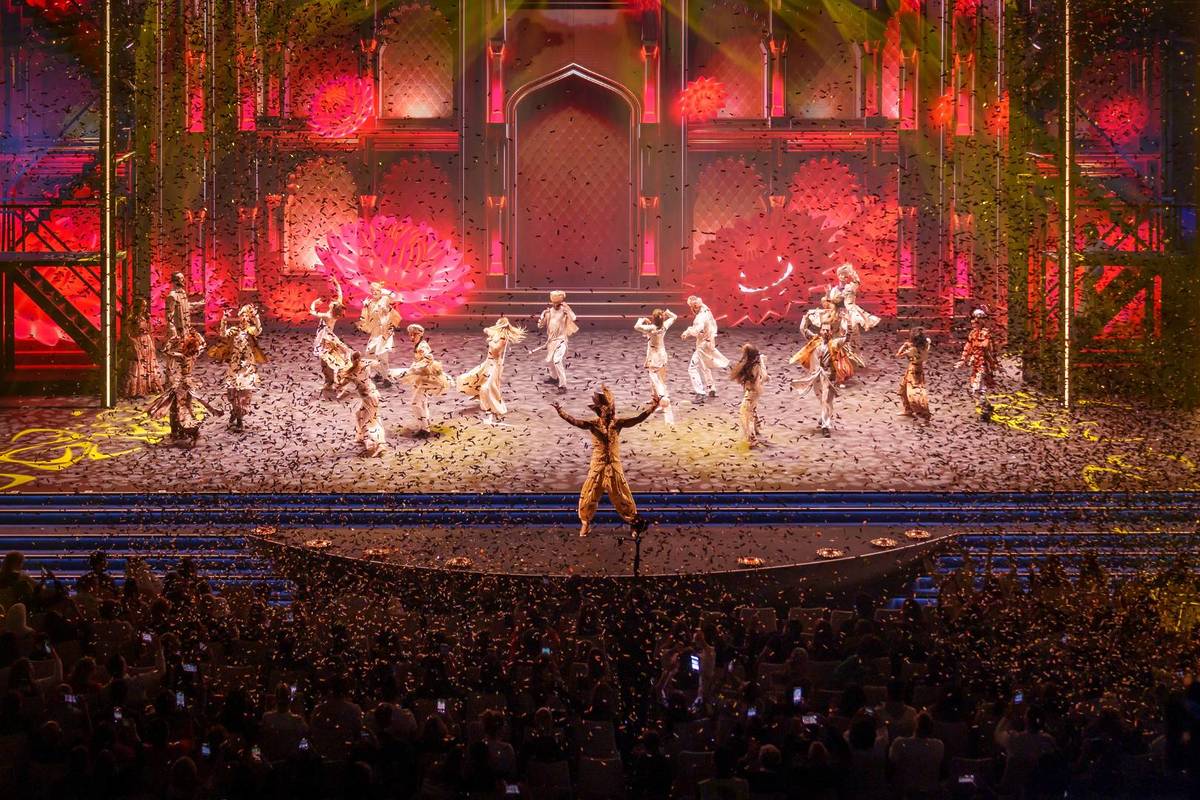 The cast centre stage during a musical and dance number with confetti flooding the hall